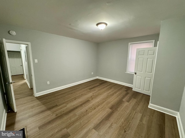 empty room with hardwood / wood-style flooring