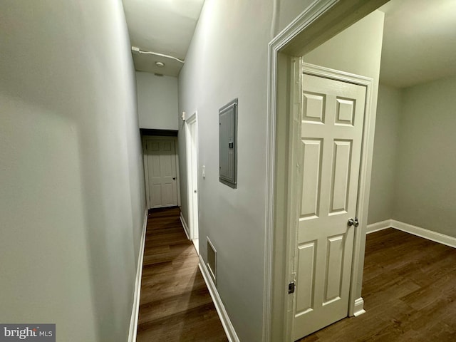 hallway featuring dark wood-type flooring and electric panel