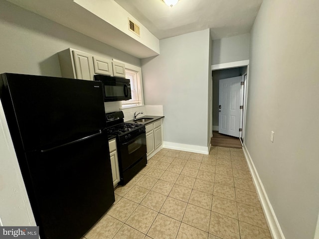 kitchen with white cabinets, sink, and black appliances