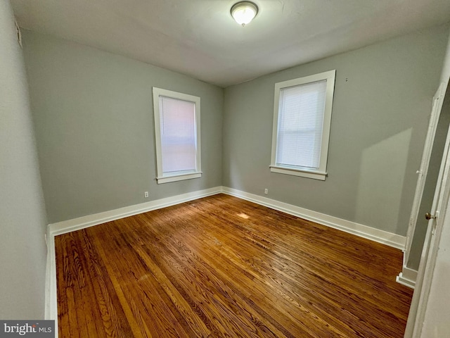 unfurnished room with hardwood / wood-style floors and plenty of natural light