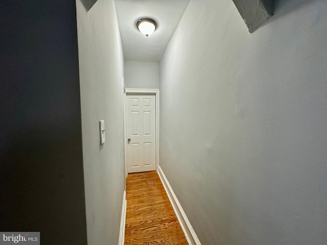 hall with hardwood / wood-style floors