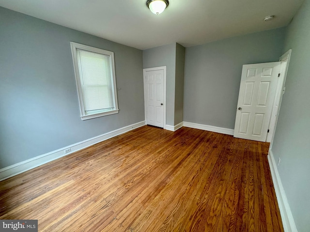 unfurnished bedroom featuring hardwood / wood-style floors