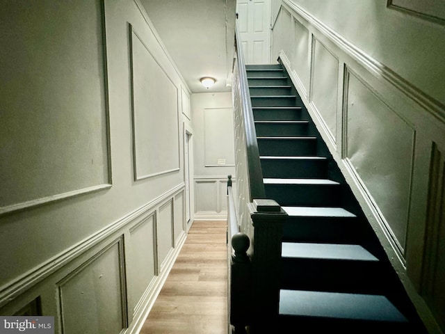 stairway featuring wood-type flooring