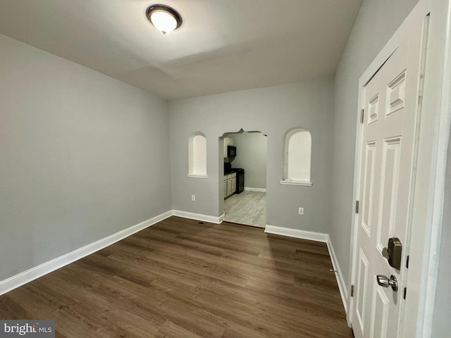 spare room with dark hardwood / wood-style flooring