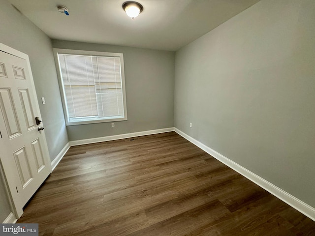 empty room with dark wood-type flooring