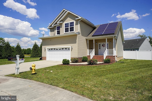 view of front of property featuring a garage, a front yard, covered porch, and solar panels