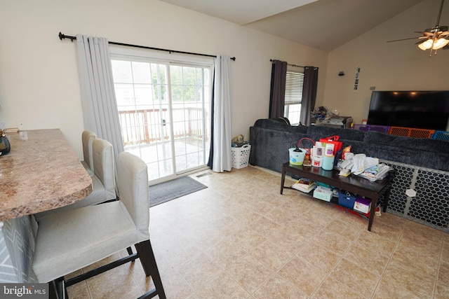 living room featuring ceiling fan and vaulted ceiling