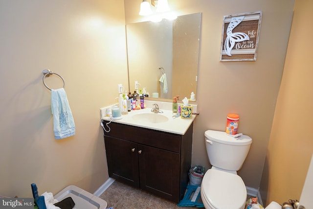 bathroom featuring vanity, tile patterned floors, and toilet