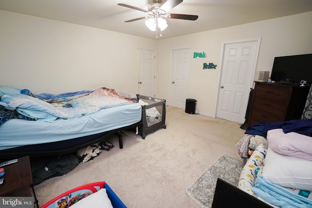 bedroom with ceiling fan and light colored carpet