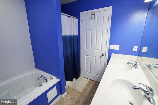 bathroom featuring tile patterned floors, a tub to relax in, and vanity