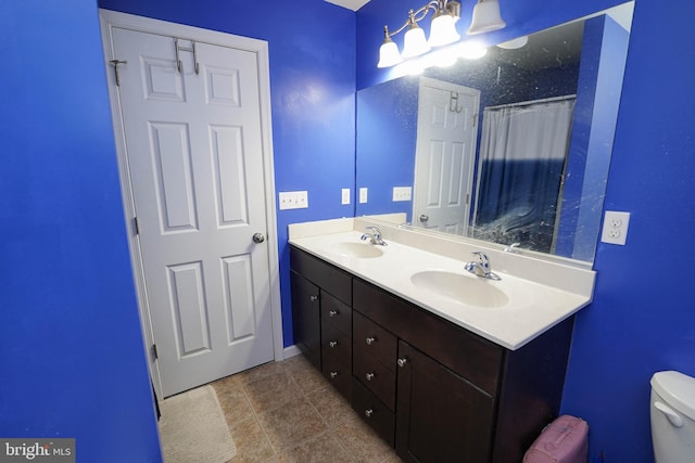 bathroom featuring vanity, tile patterned flooring, and toilet