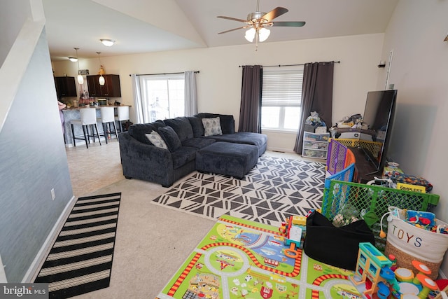 living room with lofted ceiling, light colored carpet, and ceiling fan