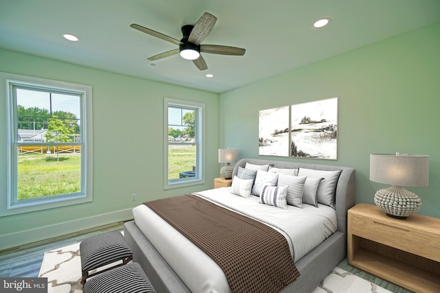 bedroom featuring light wood-type flooring and ceiling fan