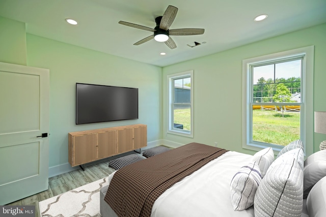 bedroom with ceiling fan and light hardwood / wood-style flooring