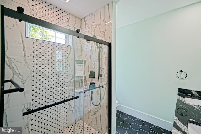 bathroom with an enclosed shower and toilet