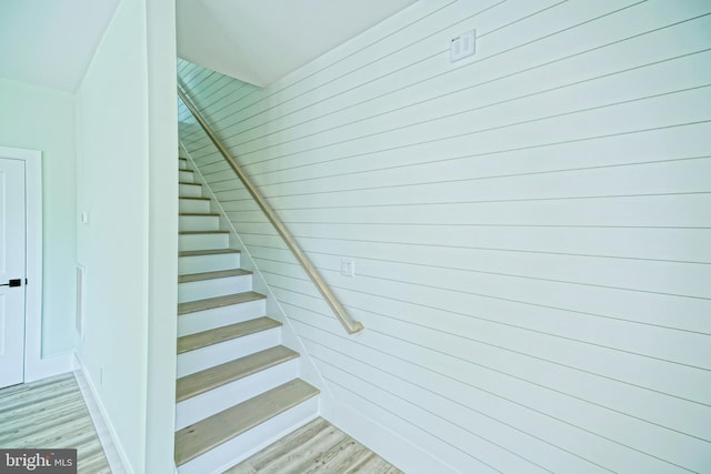 staircase with hardwood / wood-style flooring