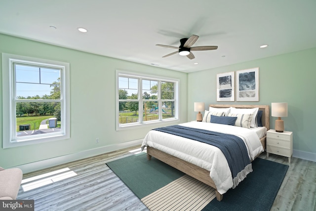 bedroom featuring ceiling fan and light hardwood / wood-style floors