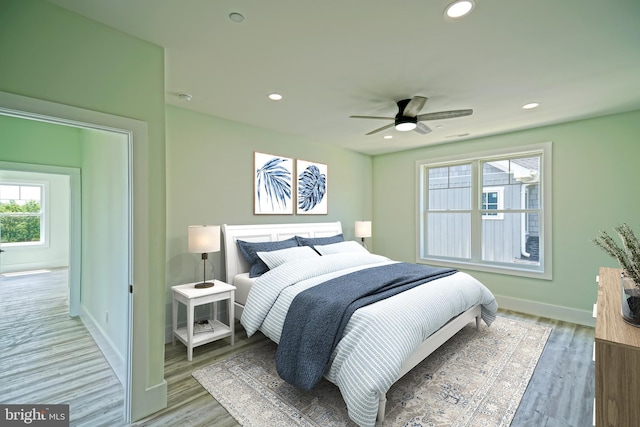 bedroom featuring hardwood / wood-style flooring and ceiling fan