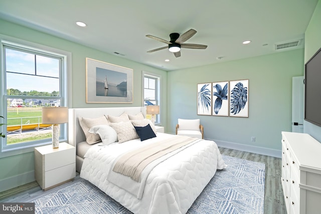 bedroom with ceiling fan and light wood-type flooring