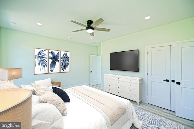 bedroom featuring a closet, ceiling fan, and light hardwood / wood-style flooring