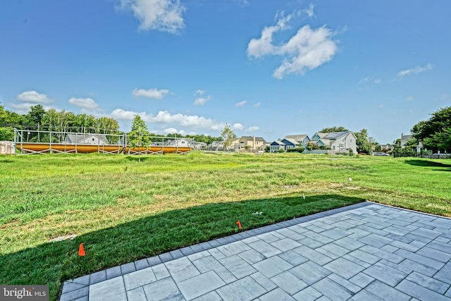 view of property's community with a patio area and a yard