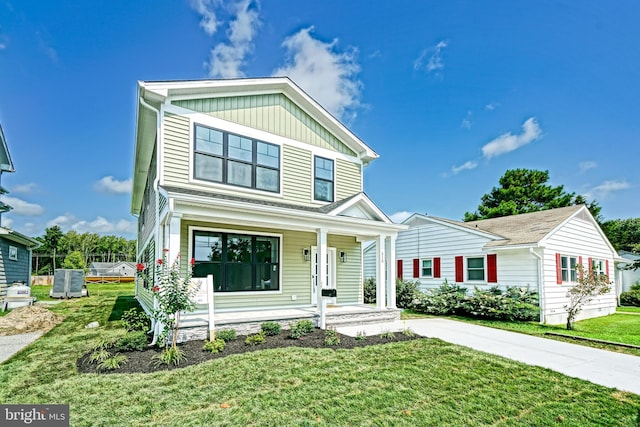 view of front of home featuring covered porch and a front lawn