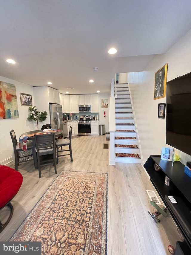 living room with light hardwood / wood-style flooring