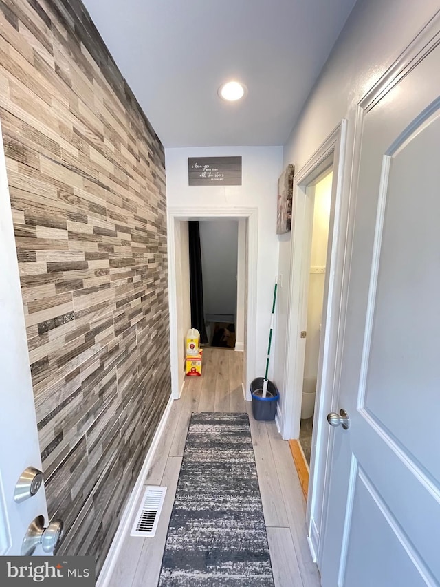 hallway with light hardwood / wood-style flooring