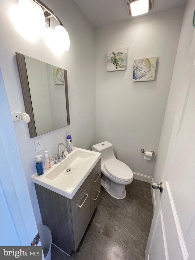 bathroom featuring vanity and toilet