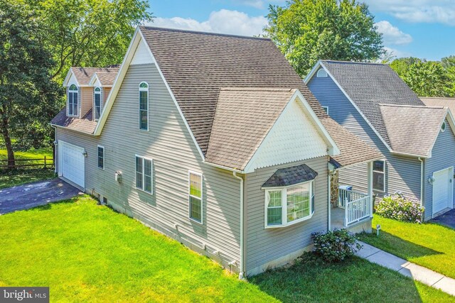 exterior space featuring a garage and a yard