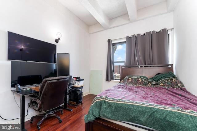 bedroom with beamed ceiling and wood-type flooring