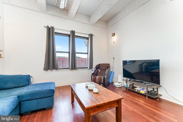 living room with hardwood / wood-style floors and beam ceiling