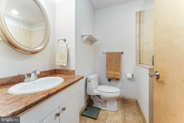 bathroom featuring tile patterned flooring, vanity, and toilet