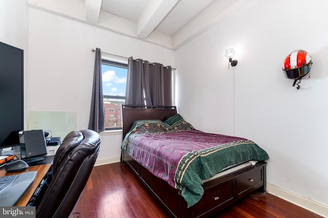 bedroom with beamed ceiling and dark hardwood / wood-style flooring