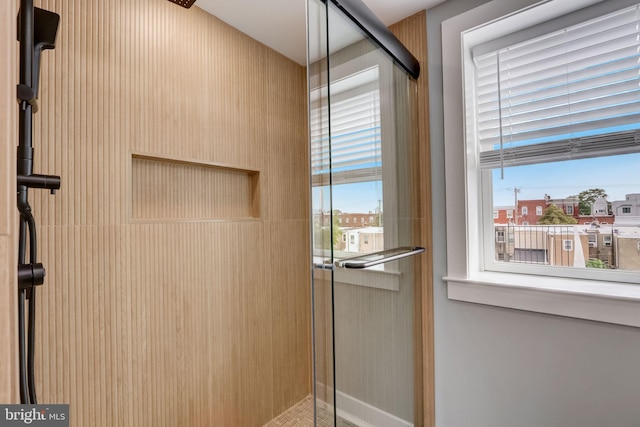 bathroom with a shower with door