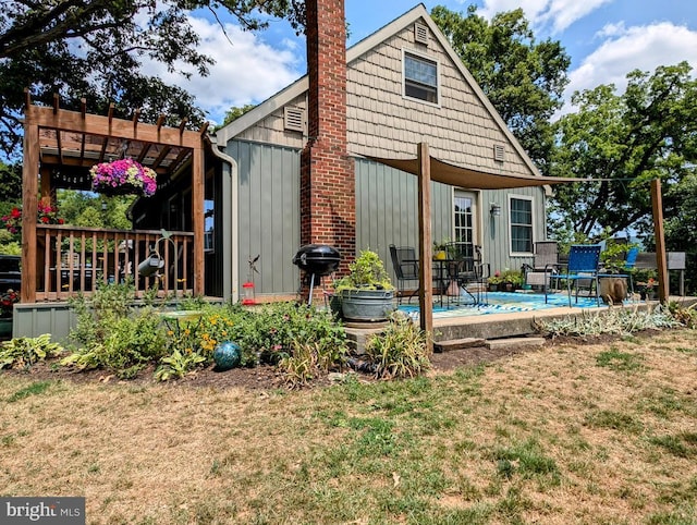 exterior space featuring a pergola and a lawn