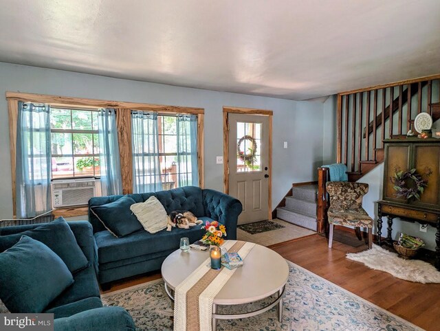 living room featuring hardwood / wood-style floors, a healthy amount of sunlight, and cooling unit