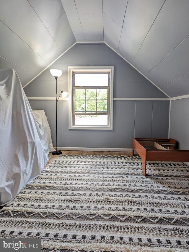 additional living space with carpet and vaulted ceiling