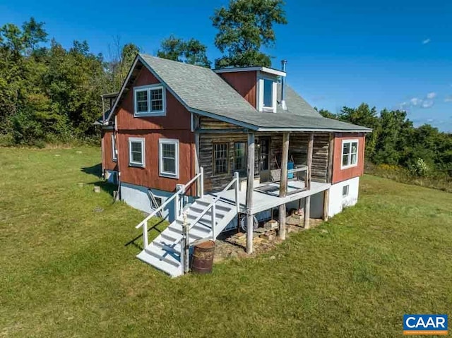 rear view of property with a lawn and a porch