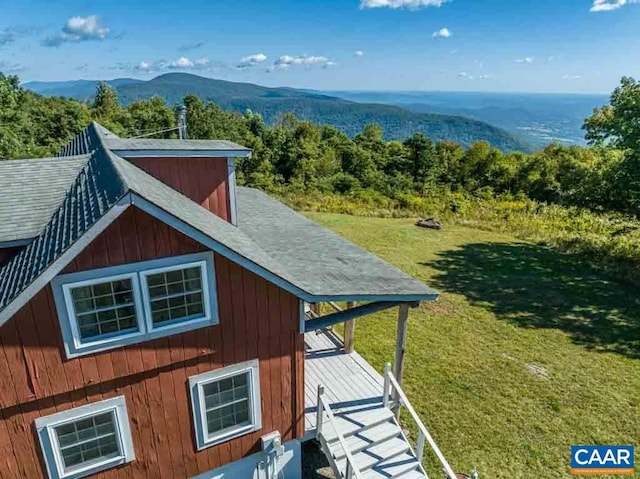 view of home's exterior featuring a lawn and a mountain view