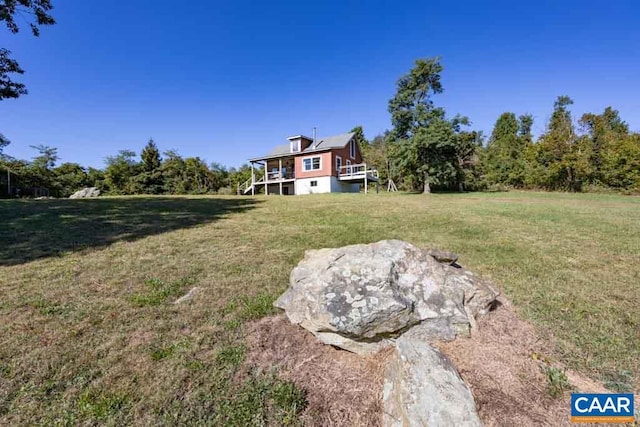 view of yard with a rural view and a deck