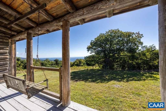 wooden deck featuring a yard