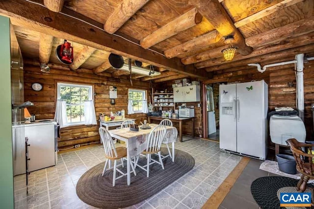 dining space with beamed ceiling and rustic walls