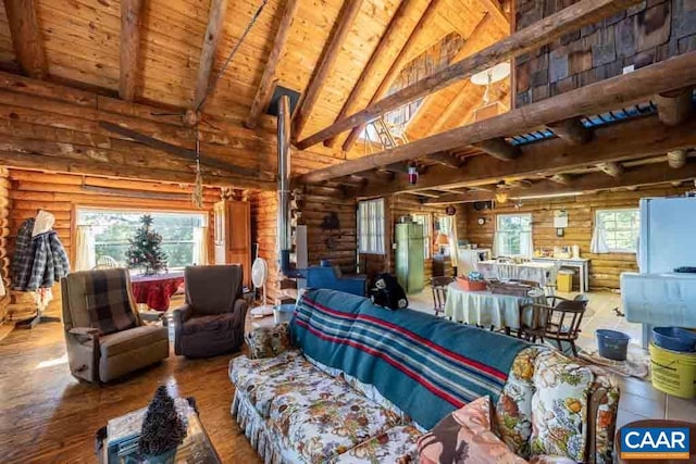 living room featuring rustic walls, vaulted ceiling with beams, wood-type flooring, track lighting, and wood ceiling