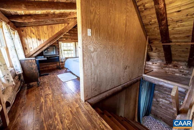 additional living space featuring vaulted ceiling with beams, wood ceiling, dark wood-type flooring, and wooden walls