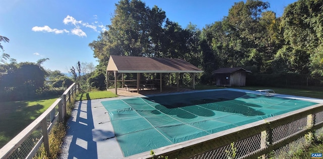 view of swimming pool featuring a gazebo and a storage unit