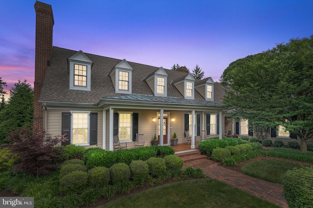 cape cod-style house with a porch