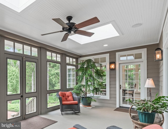 sunroom featuring a skylight and ceiling fan