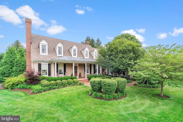 cape cod house featuring a porch and a front lawn