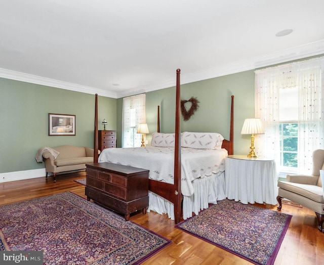 bedroom featuring wood-type flooring and ornamental molding